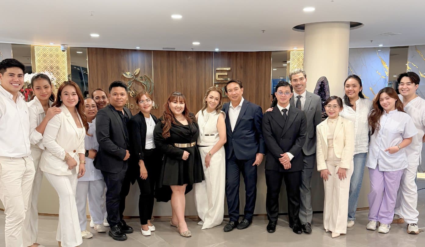 The BioRenew team standing together in the clinic reception area, dressed in formal and clinical attire.